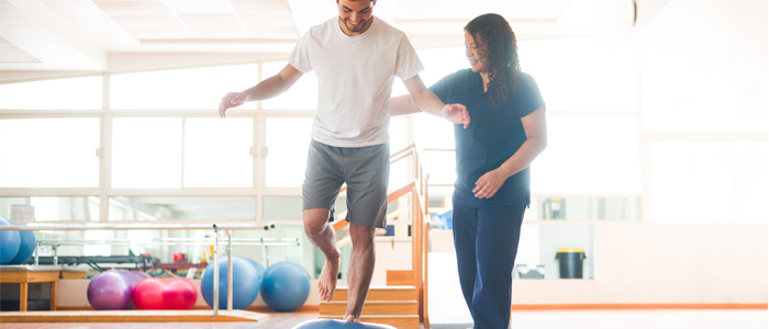 a man trying to balance on one leg